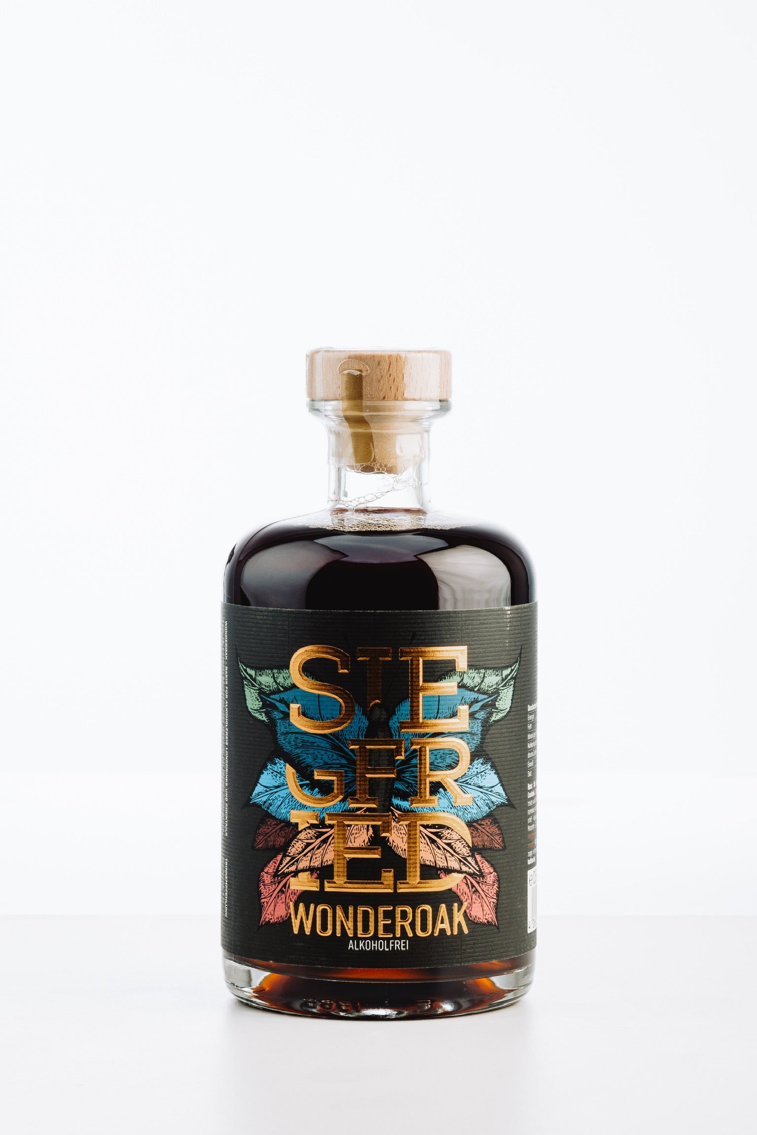 Siegfried Wonderoak alkoholfrei – stilvolle Flasche mit dunkler, bernsteinfarbener Flüssigkeit, markantes Etikett in Schwarz mit farbigen Blättern und Holzverschluss, ideal für alkoholfreie Drinks mit Cola oder Ginger Beer